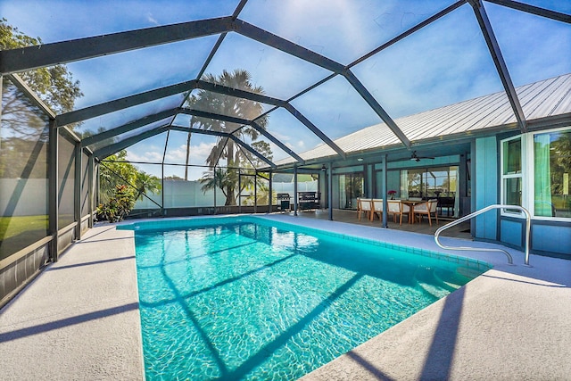 pool featuring a patio area and glass enclosure