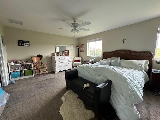 bedroom with visible vents, carpet, and a ceiling fan