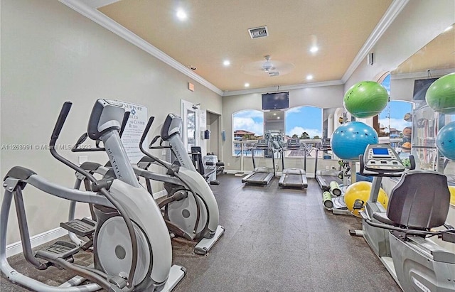 workout area with visible vents, crown molding, and baseboards