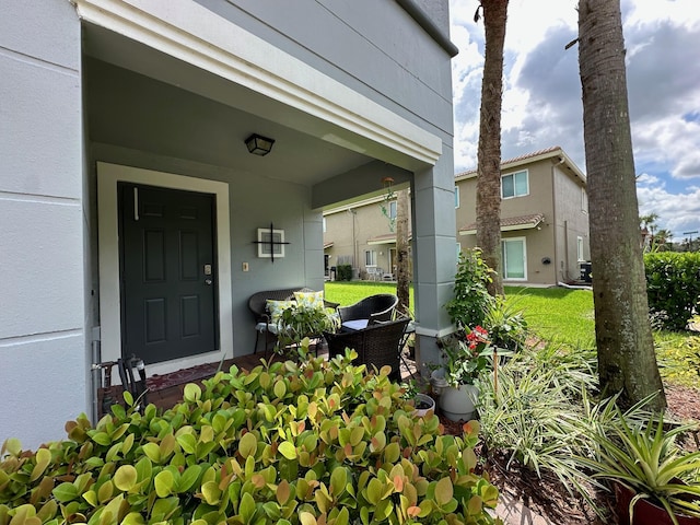 view of exterior entry with a porch