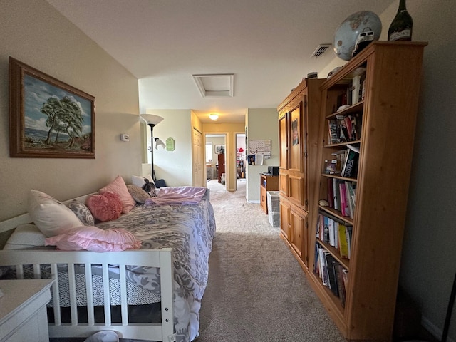 bedroom featuring attic access, visible vents, and light carpet