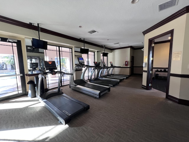 gym with visible vents, a textured ceiling, and ornamental molding