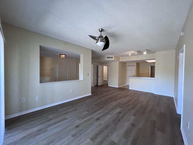 spare room featuring baseboards and dark wood-type flooring