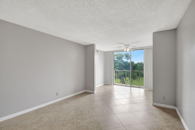 unfurnished room featuring light tile patterned floors, a textured ceiling, baseboards, and a ceiling fan