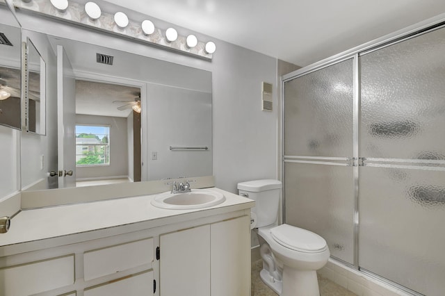 bathroom featuring visible vents, a shower stall, toilet, and vanity