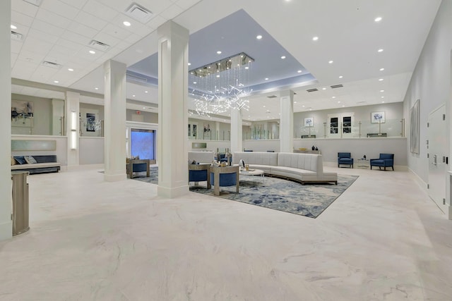 living area with visible vents, decorative columns, and recessed lighting