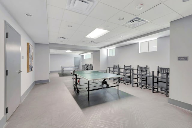 recreation room with baseboards, visible vents, and a drop ceiling