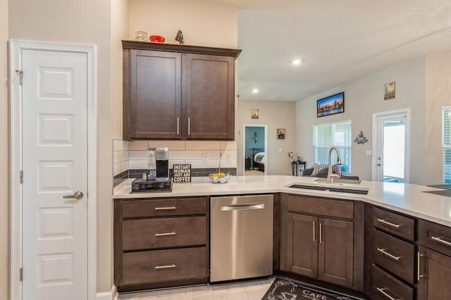 kitchen with a sink, dark brown cabinetry, light countertops, dishwasher, and tasteful backsplash