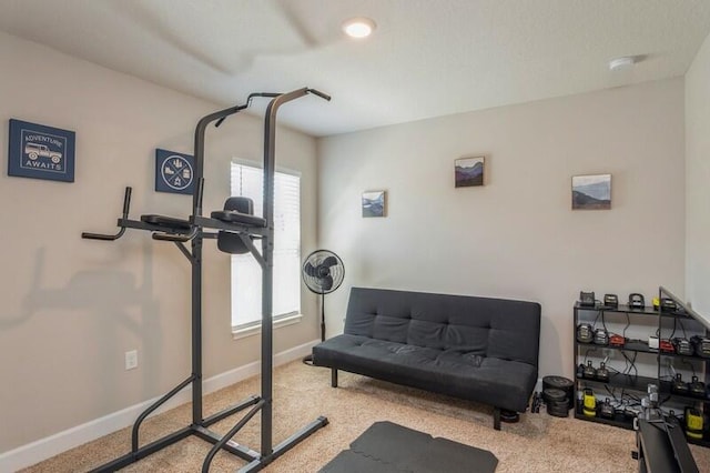 exercise room with carpet and baseboards