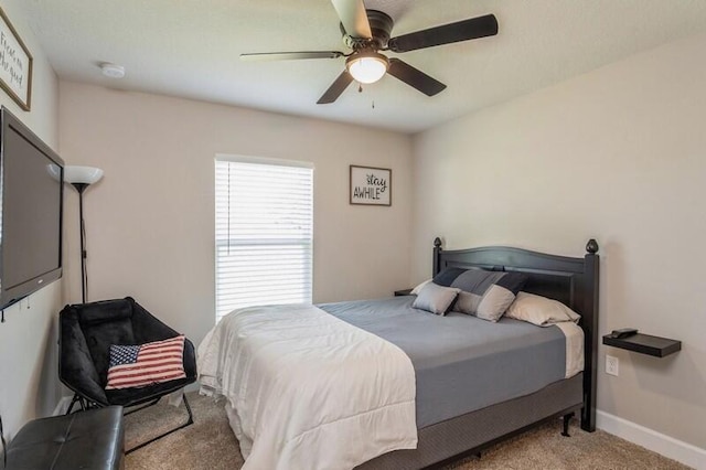 carpeted bedroom with baseboards and a ceiling fan