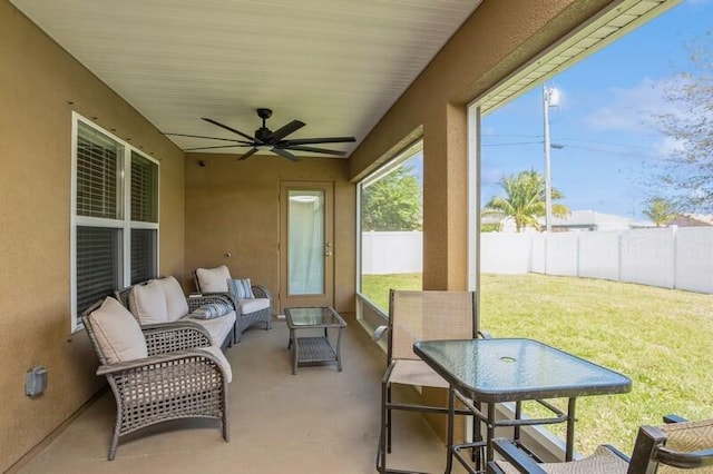 sunroom with a ceiling fan