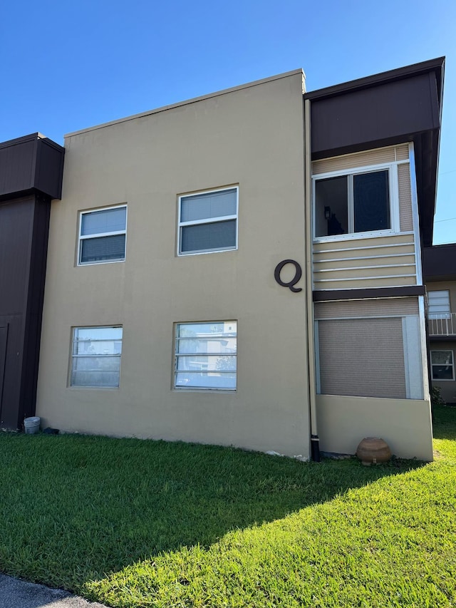 774 Burgundy Q, Delray Beach, FL 33484 - view of home's exterior featuring a lawn and stucco siding