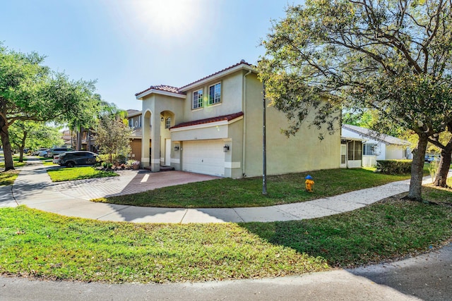 view of front of house with stucco siding, driveway, a tile roof, a front yard, and a garage