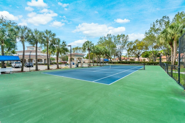 view of tennis court featuring fence