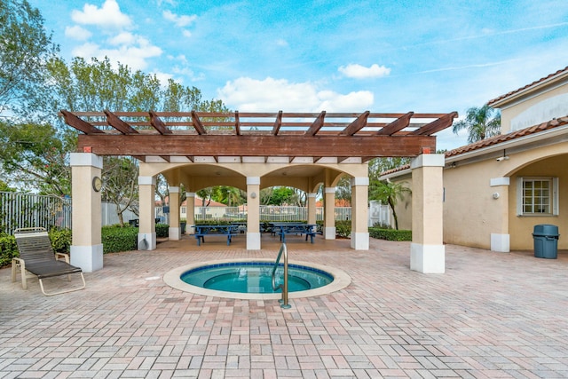 view of swimming pool with a patio, fence, a community hot tub, and a pergola