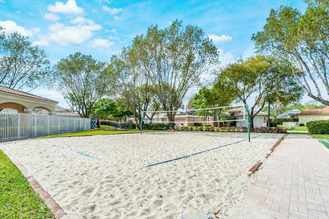 view of home's community with volleyball court and fence