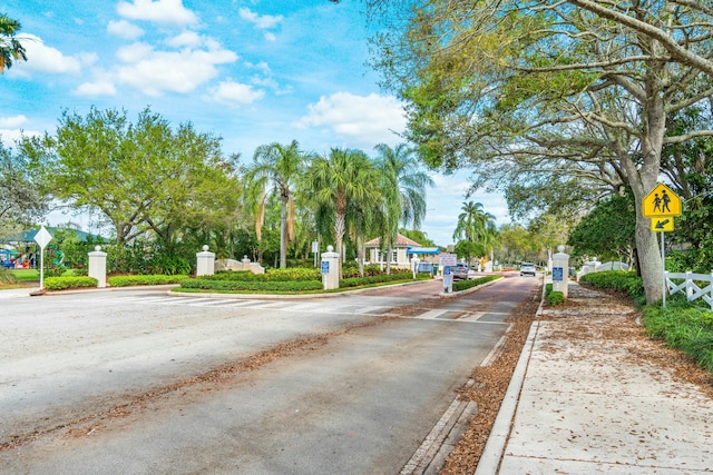 view of road with curbs, traffic signs, and sidewalks