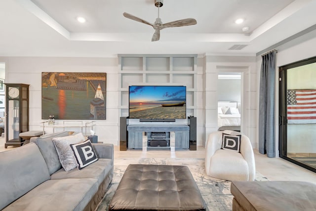 living room with visible vents, recessed lighting, a raised ceiling, and ceiling fan