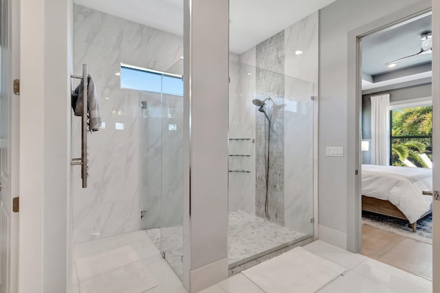 full bathroom with a marble finish shower, connected bathroom, tile patterned floors, and a wealth of natural light