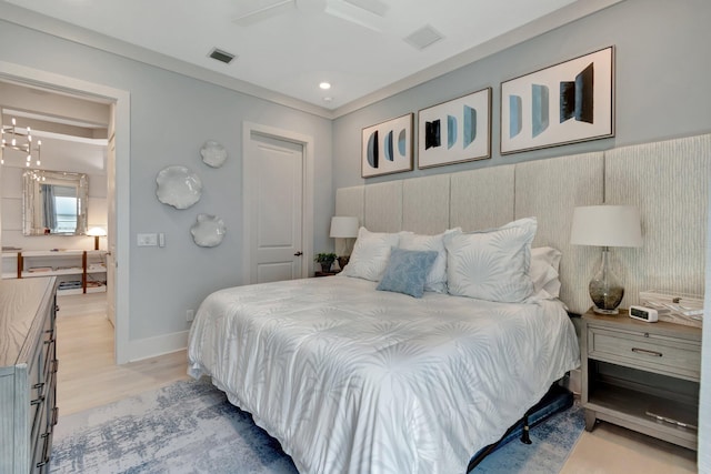 bedroom with visible vents, ceiling fan with notable chandelier, recessed lighting, light wood finished floors, and baseboards