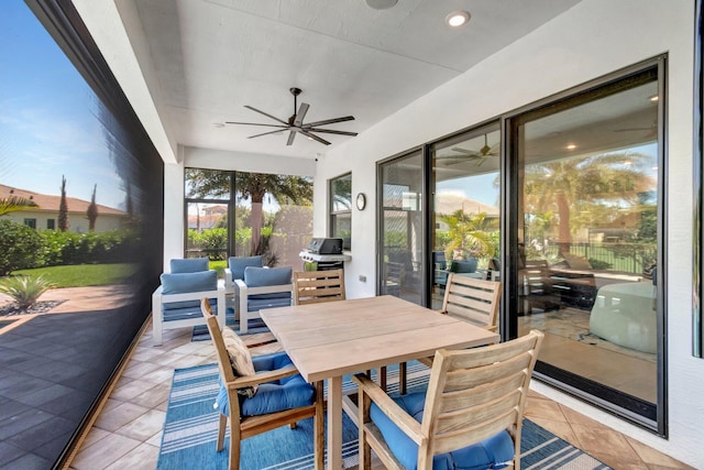 view of patio featuring grilling area, outdoor dining space, and a ceiling fan