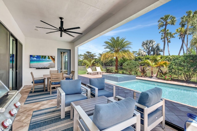 view of patio featuring an outdoor hangout area, a fenced backyard, a ceiling fan, and a pool with connected hot tub