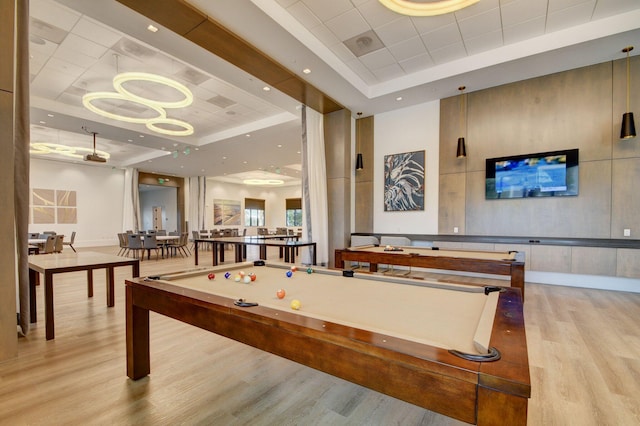 game room with a raised ceiling, wood finished floors, recessed lighting, pool table, and baseboards