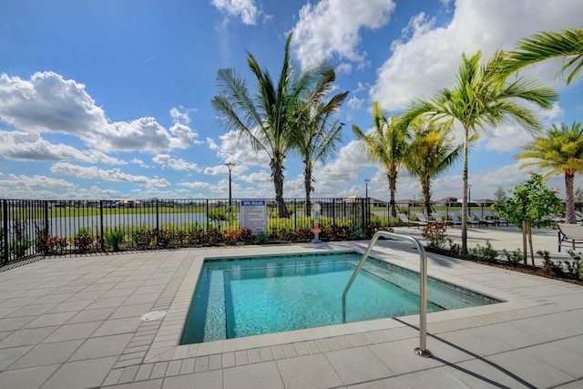 view of pool featuring a patio, a pool, and fence