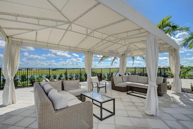 view of patio / terrace featuring a gazebo, outdoor lounge area, and a fenced backyard