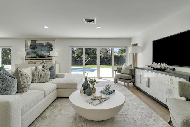 living area featuring visible vents, recessed lighting, and light wood-type flooring