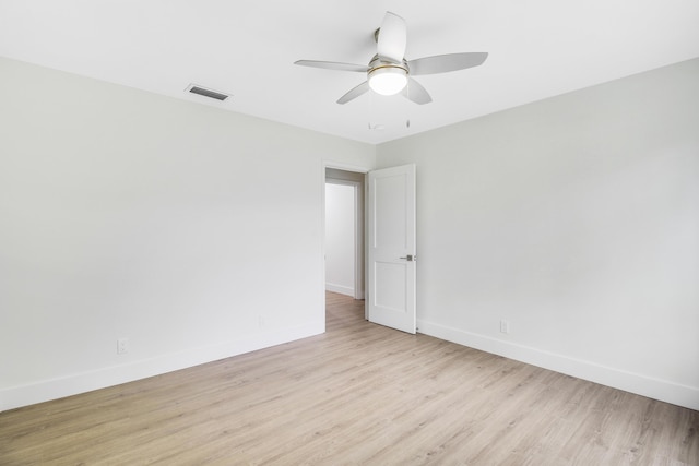 empty room featuring ceiling fan, visible vents, baseboards, and light wood-style flooring