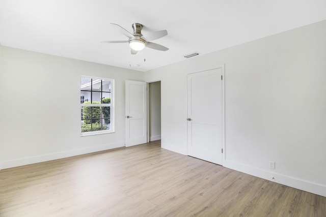 spare room with baseboards, visible vents, and light wood-type flooring