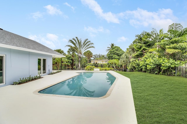 outdoor pool featuring a patio area, a yard, and fence