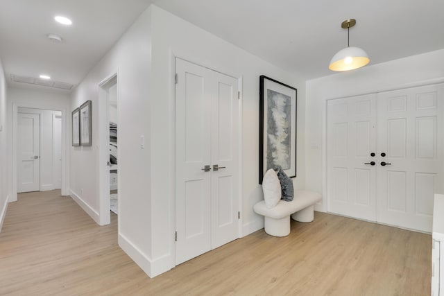 foyer entrance with recessed lighting, baseboards, and light wood finished floors