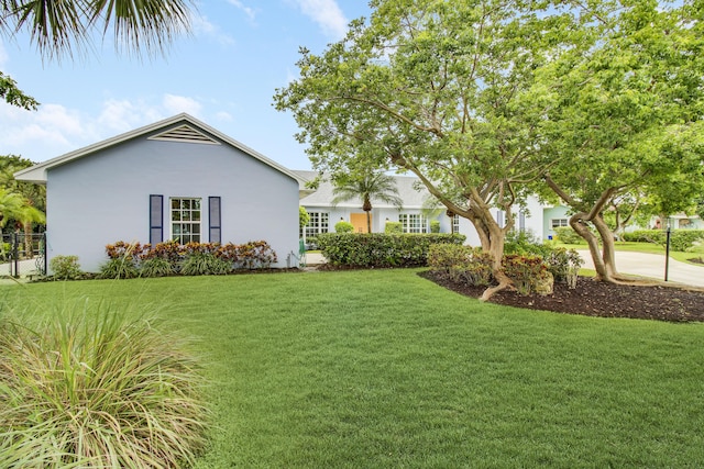 view of yard featuring an attached garage and driveway