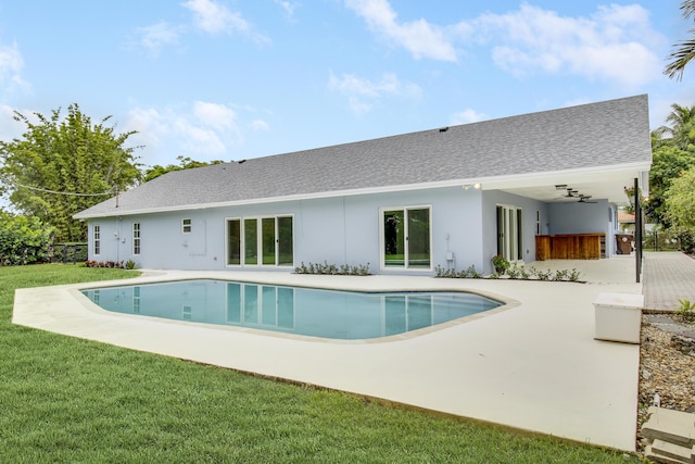 pool with a patio and a yard