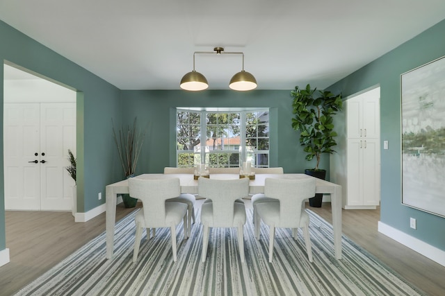 dining room with light wood-style flooring and baseboards