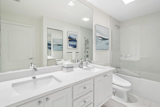 full bath featuring a sink, toilet, double vanity, and bathing tub / shower combination