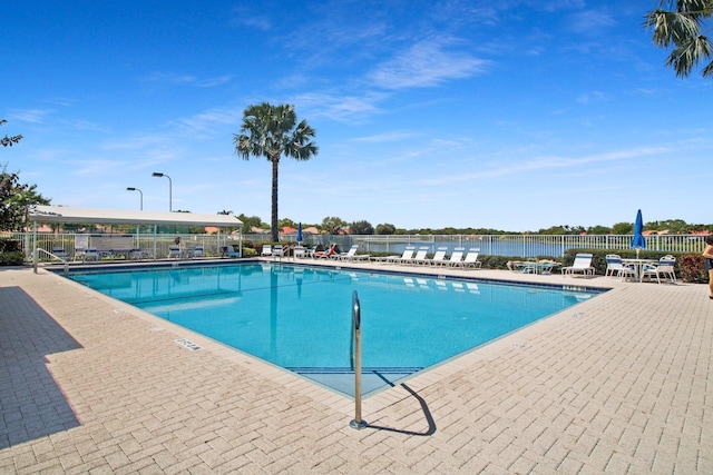 community pool featuring a patio area and fence