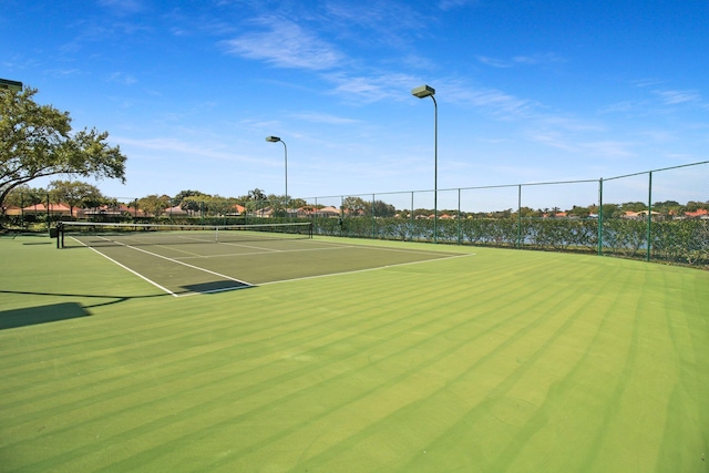 view of sport court featuring fence