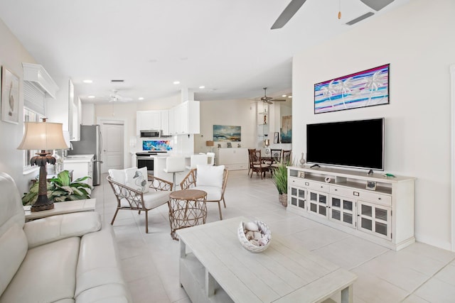 living room with recessed lighting, light tile patterned flooring, and a ceiling fan