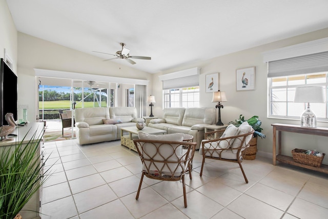 living room with lofted ceiling, light tile patterned flooring, and a ceiling fan