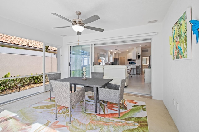 dining area with tile patterned floors, visible vents, and ceiling fan