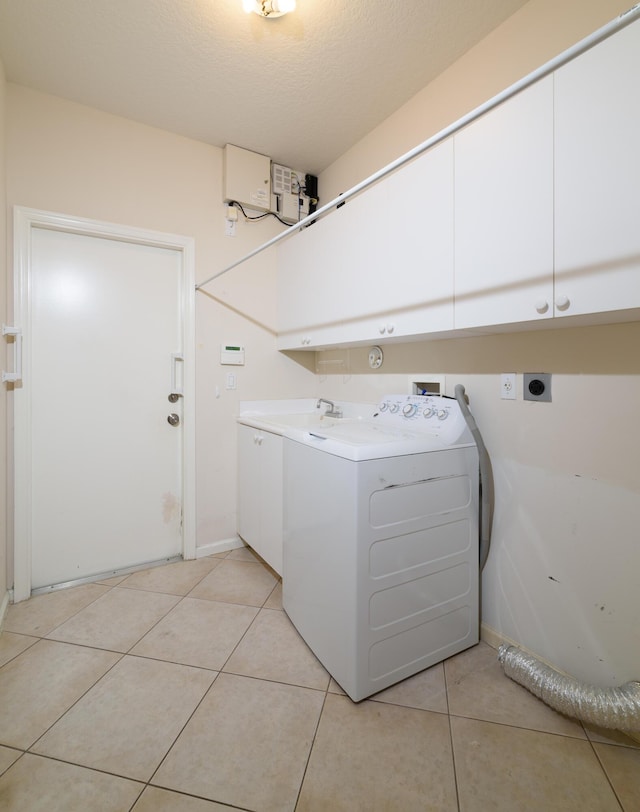 10102 Diamond Lake Rd, Boynton Beach, FL 33437 - washroom featuring cabinet space, light tile patterned floors, washer / dryer, and a textured ceiling