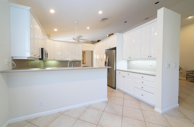 10102 Diamond Lake Rd, Boynton Beach, FL 33437 - kitchen featuring a ceiling fan, white cabinetry, stainless steel appliances, a peninsula, and light countertops