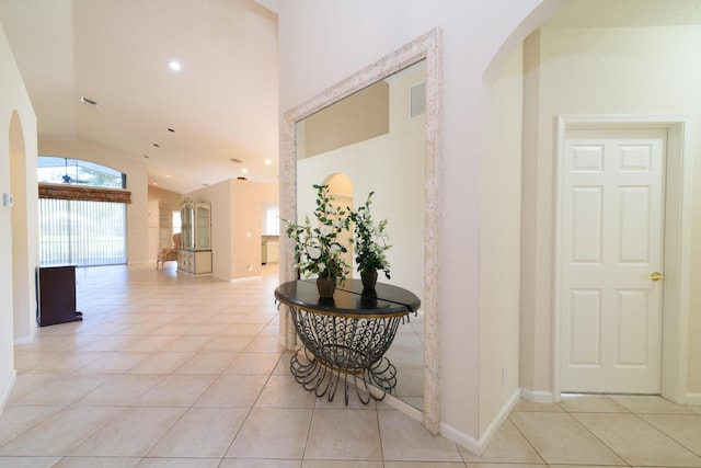 10102 Diamond Lake Rd, Boynton Beach, FL 33437 - corridor featuring baseboards, vaulted ceiling, recessed lighting, arched walkways, and light tile patterned flooring