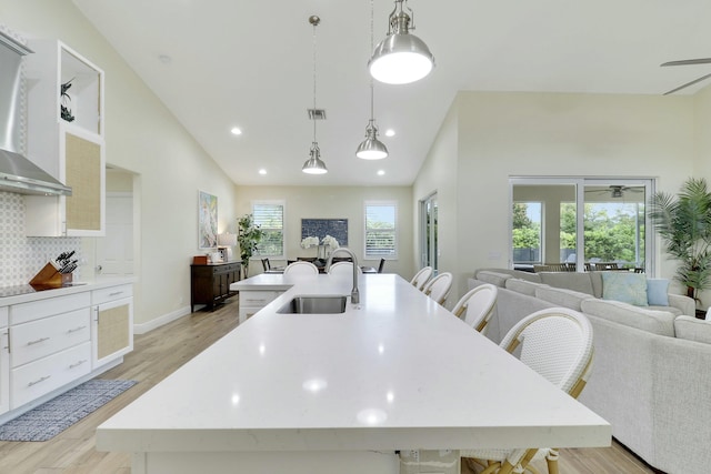 kitchen with open floor plan, light countertops, and a sink