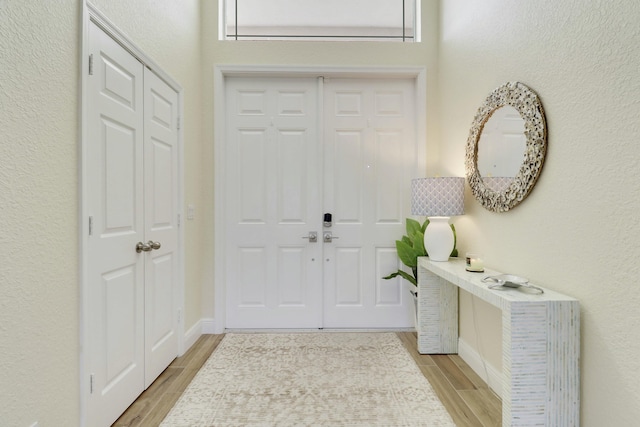 foyer with wood finish floors and baseboards