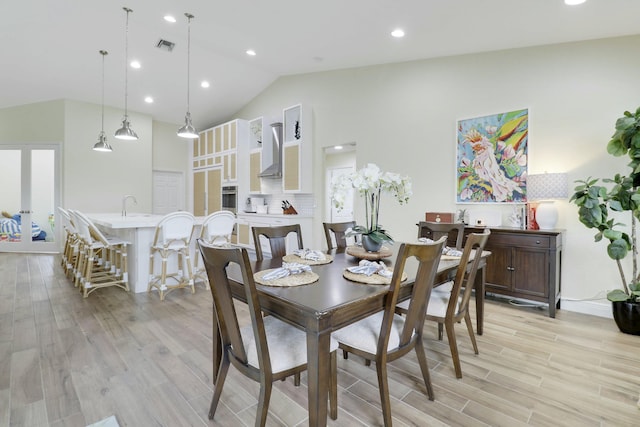 dining room featuring visible vents, high vaulted ceiling, light wood-style flooring, and recessed lighting