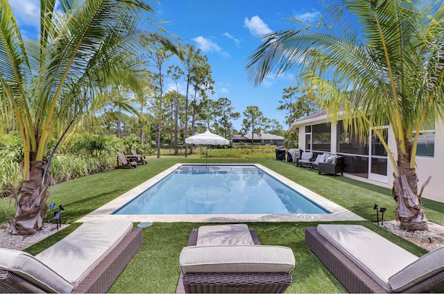 outdoor pool featuring an outdoor hangout area and a yard